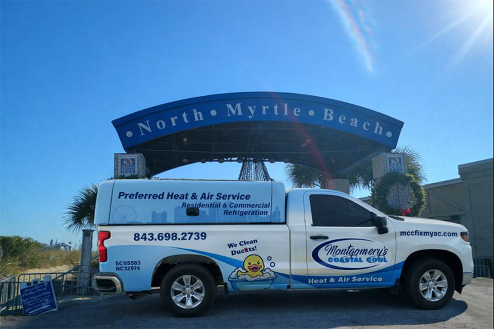 AC repair truck in front of the North Myrtle Beach sign near Main Street North Myrtle Beach SC